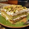 Close-up of Pistachio Tiramisu with layers of mascarpone cream and espresso-soaked ladyfingers.